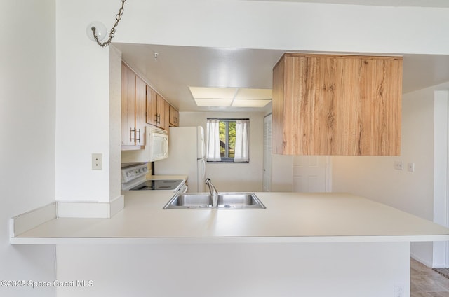 1714 University Ln Unit 201, Cocoa, FL 32922 - kitchen featuring white appliances, a sink, a peninsula, and light countertops