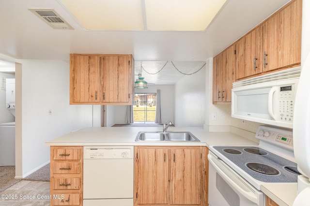 1714 University Ln Unit 201, Cocoa, FL 32922 - kitchen featuring white appliances, a sink, light countertops, a peninsula, and light colored carpet