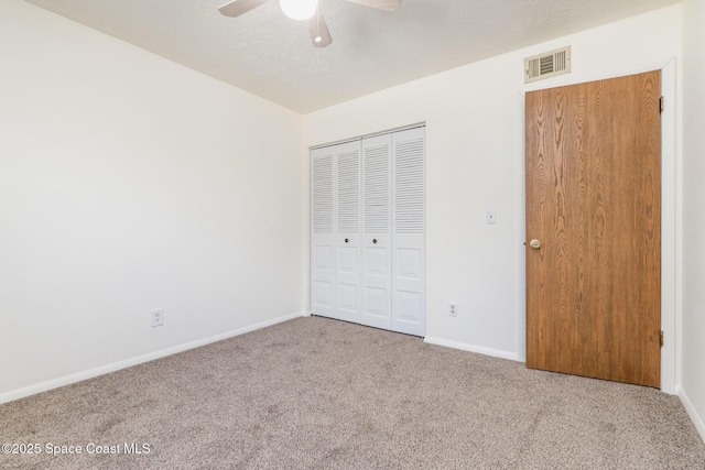 1714 University Ln Unit 201, Cocoa, FL 32922 - unfurnished bedroom with carpet flooring, baseboards, a closet, and ceiling fan