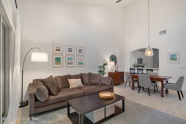 1629 Baseline Ln, Vero Beach, FL 32967 - living room featuring a high ceiling, arched walkways, and light tile patterned flooring