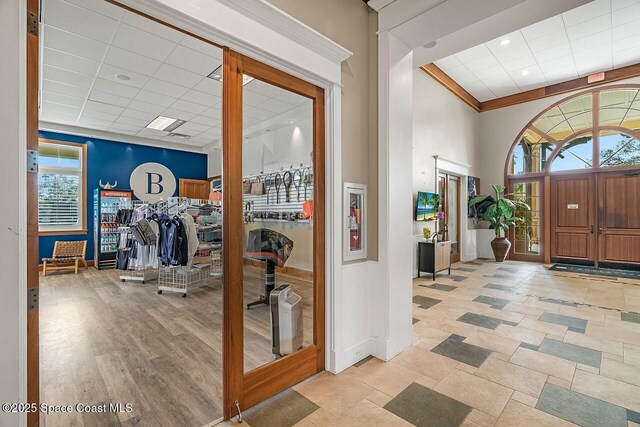 1629 Baseline Ln, Vero Beach, FL 32967 - entryway featuring a paneled ceiling, baseboards, a towering ceiling, and ornamental molding