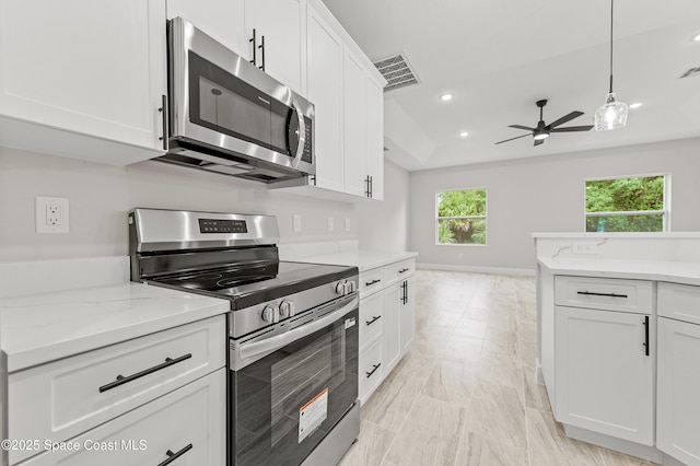 8286 100th Ave, Vero Beach, FL 32967 - kitchen featuring stainless steel appliances, ceiling fan, white cabinets, light marble finish floors, and recessed lighting