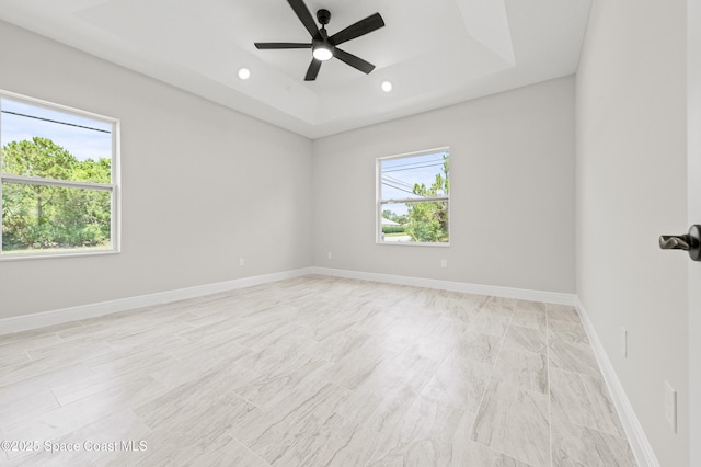 8286 100th Ave, Vero Beach, FL 32967 - spare room featuring a tray ceiling, ceiling fan, baseboards, and recessed lighting