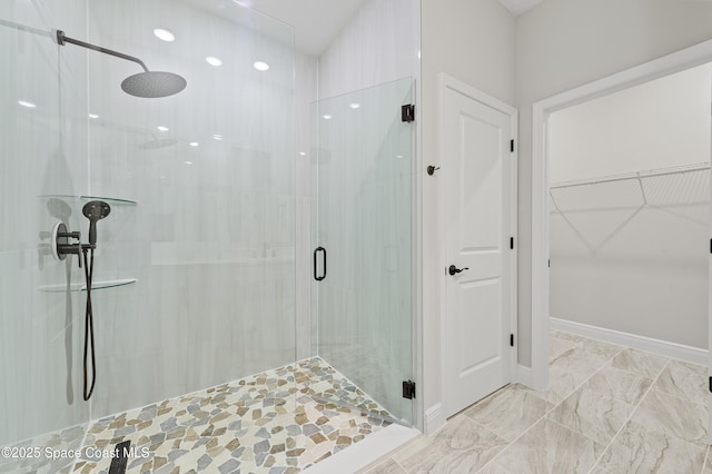 8286 100th Ave, Vero Beach, FL 32967 - bathroom featuring a stall shower, a spacious closet, and marble finish flooring