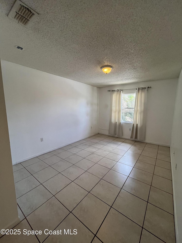 110 Summer Pl Unit 4, Merritt Island, FL 32953 - empty room featuring a textured ceiling and light tile patterned floors