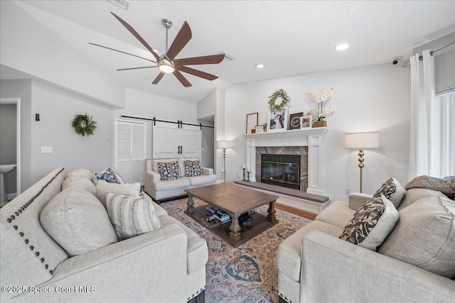 912 Hialeah St, Rockledge, FL 32955 - living area with lofted ceiling, ceiling fan, a textured ceiling, recessed lighting, and a tile fireplace