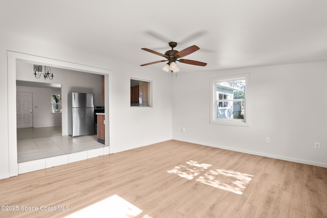 418 N Fiske Blvd, Cocoa, FL 32922 - unfurnished living room with a ceiling fan, light wood finished floors, and baseboards