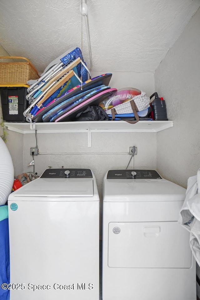 5800 N Banana River Blvd N Unit 128, Cape Canaveral, FL 32920 - laundry room with washing machine and clothes dryer and a textured ceiling