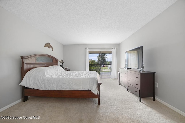 5800 N Banana River Blvd N Unit 128, Cape Canaveral, FL 32920 - bedroom featuring access to outside, light colored carpet, a textured ceiling, and baseboards