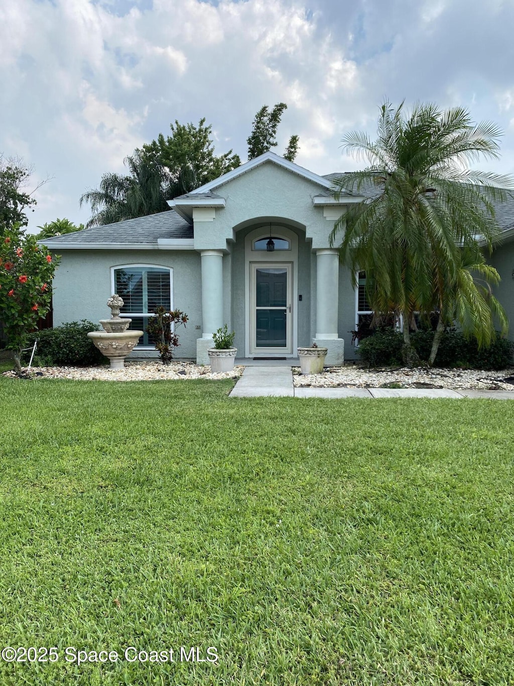 971 Sabal Grove Dr, Rockledge, FL 32955 - view of front of house with stucco siding and a front lawn