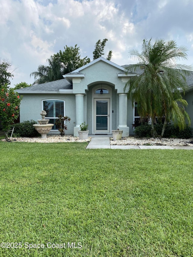 971 Sabal Grove Dr, Rockledge, FL 32955 - view of front of house with stucco siding and a front lawn