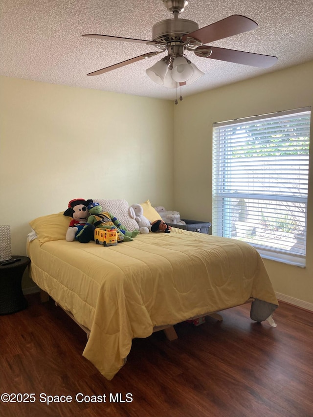 971 Sabal Grove Dr, Rockledge, FL 32955 - bedroom featuring wood finished floors, a textured ceiling, and ceiling fan