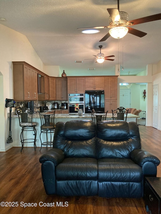 971 Sabal Grove Dr, Rockledge, FL 32955 - living room with a ceiling fan, dark wood-style flooring, and lofted ceiling