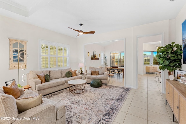 1172 Vestavia Cir, Melbourne, FL 32940 - living area with a ceiling fan, plenty of natural light, light tile patterned flooring, and baseboards