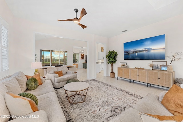 1172 Vestavia Cir, Melbourne, FL 32940 - tiled living room featuring a ceiling fan and a chandelier