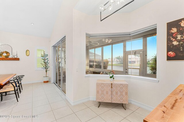 1172 Vestavia Cir, Melbourne, FL 32940 - dining space featuring tile patterned floors, baseboards, vaulted ceiling, and a water view