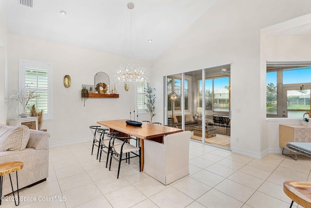 1172 Vestavia Cir, Melbourne, FL 32940 - dining room with light tile patterned flooring, a chandelier, lofted ceiling, and baseboards