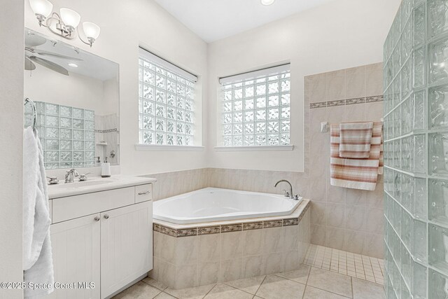 1172 Vestavia Cir, Melbourne, FL 32940 - bathroom with vanity, a bath, tile patterned flooring, ceiling fan, and a walk in shower