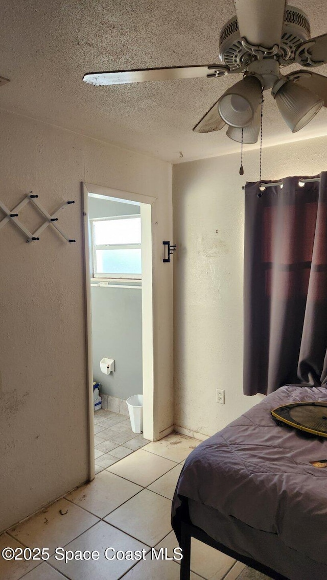 2327 Sadler Ln, Melbourne, FL 32935 - bedroom featuring light tile patterned floors, a textured ceiling, and a ceiling fan