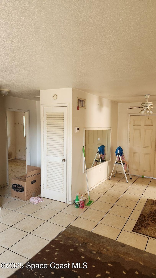 2327 Sadler Ln, Melbourne, FL 32935 - foyer with tile patterned flooring, a textured ceiling, and ceiling fan