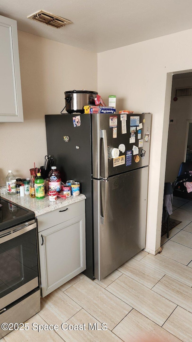 2327 Sadler Ln, Melbourne, FL 32935 - kitchen with stainless steel appliances and wood tiled floors