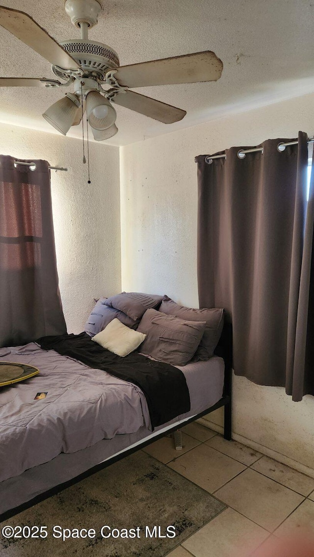 2327 Sadler Ln, Melbourne, FL 32935 - bedroom featuring tile patterned floors, a ceiling fan, and a textured wall