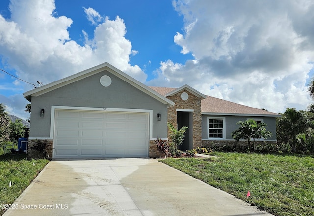 571 Fondulac St, Palm Bay, FL 32908 - single story home featuring stone siding, concrete driveway, stucco siding, and a front lawn