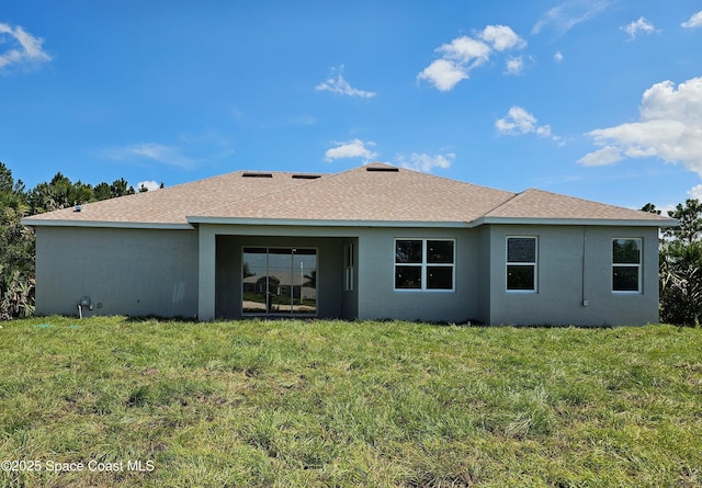 571 Fondulac St, Palm Bay, FL 32908 - back of property featuring roof with shingles, a yard, and stucco siding
