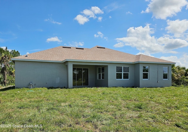 571 Fondulac St, Palm Bay, FL 32908 - back of property with stucco siding, a yard, and roof with shingles