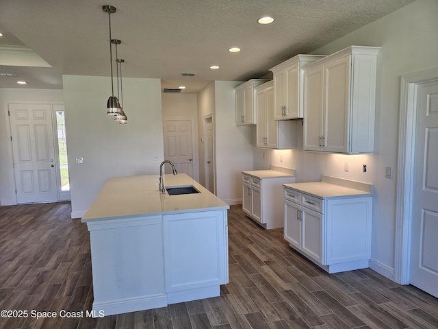 571 Fondulac St, Palm Bay, FL 32908 - kitchen with dark wood finished floors, white cabinets, a center island with sink, recessed lighting, and a textured ceiling