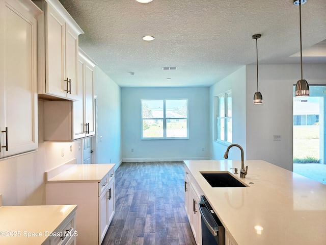 571 Fondulac St, Palm Bay, FL 32908 - kitchen featuring dishwasher, dark wood-style flooring, a textured ceiling, light countertops, and white cabinets