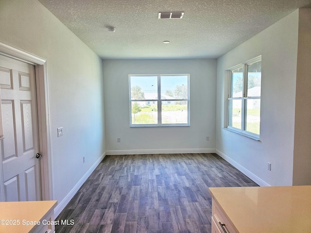 571 Fondulac St, Palm Bay, FL 32908 - unfurnished room with plenty of natural light, dark wood-type flooring, a textured ceiling, and a smoke detector
