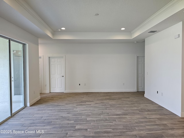 571 Fondulac St, Palm Bay, FL 32908 - empty room featuring a tray ceiling, wood finished floors, crown molding, and recessed lighting