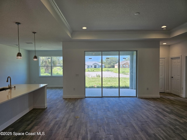 571 Fondulac St, Palm Bay, FL 32908 - unfurnished living room featuring a tray ceiling, ornamental molding, dark wood-type flooring, a textured ceiling, and recessed lighting