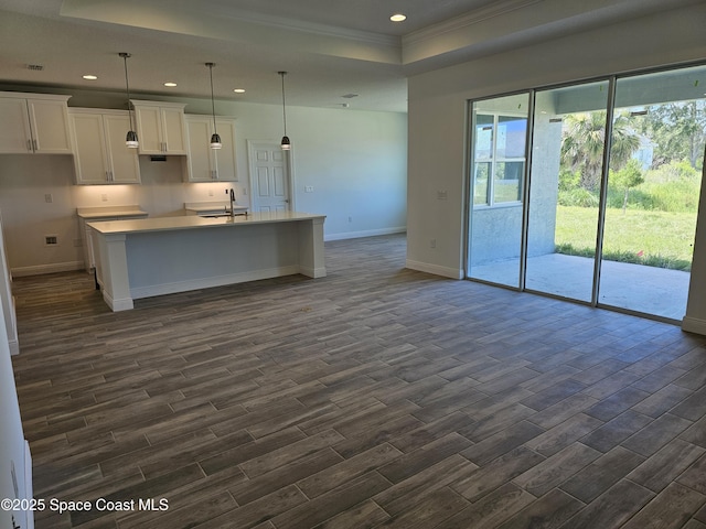 571 Fondulac St, Palm Bay, FL 32908 - kitchen featuring dark wood finished floors, white cabinets, crown molding, recessed lighting, and an island with sink