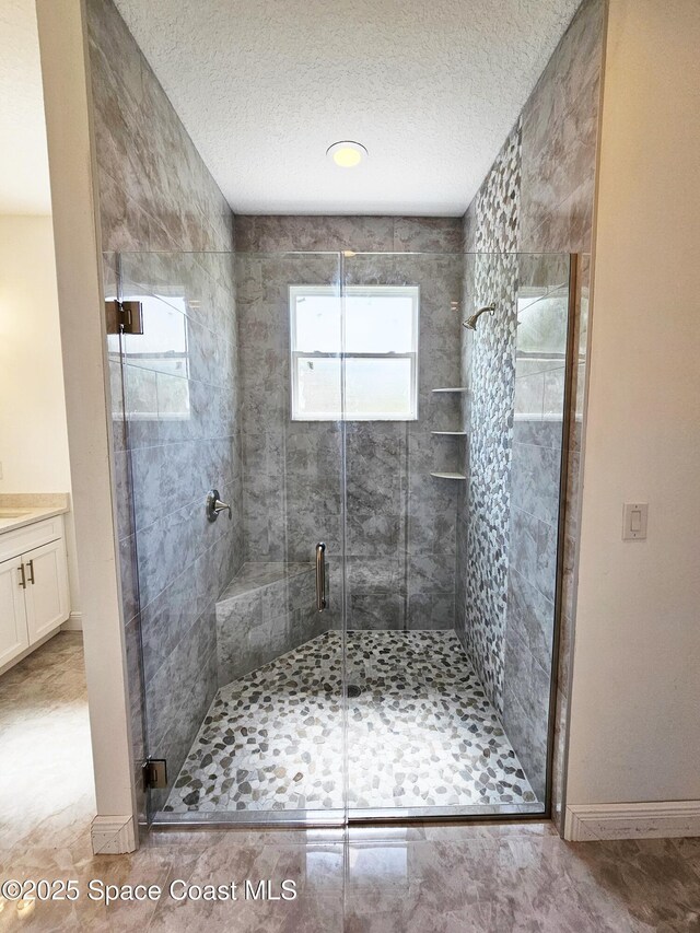571 Fondulac St, Palm Bay, FL 32908 - bathroom featuring a shower stall, vanity, and a textured ceiling
