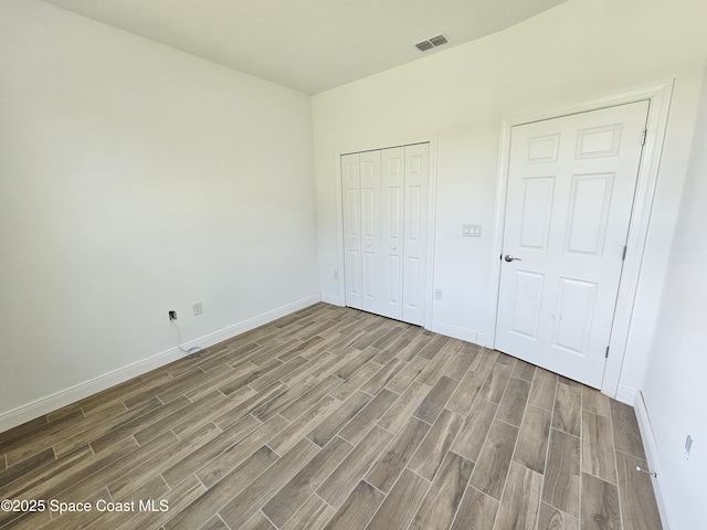 571 Fondulac St, Palm Bay, FL 32908 - unfurnished bedroom featuring wood finished floors and a closet