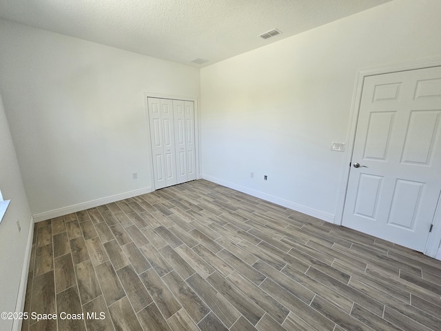 571 Fondulac St, Palm Bay, FL 32908 - unfurnished room featuring wood finished floors and a textured ceiling
