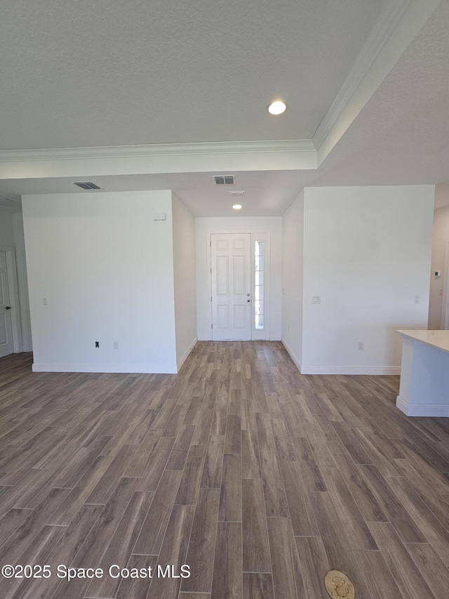 571 Fondulac St, Palm Bay, FL 32908 - entrance foyer featuring dark wood finished floors, crown molding, recessed lighting, a raised ceiling, and a textured ceiling