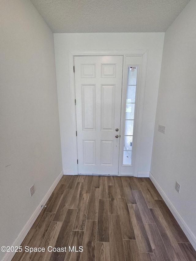 571 Fondulac St, Palm Bay, FL 32908 - entrance foyer featuring dark wood-style flooring and a textured ceiling