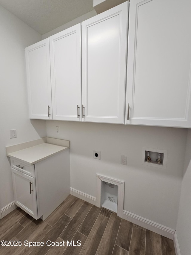 571 Fondulac St, Palm Bay, FL 32908 - washroom with cabinet space, hookup for an electric dryer, dark wood-style flooring, and washer hookup