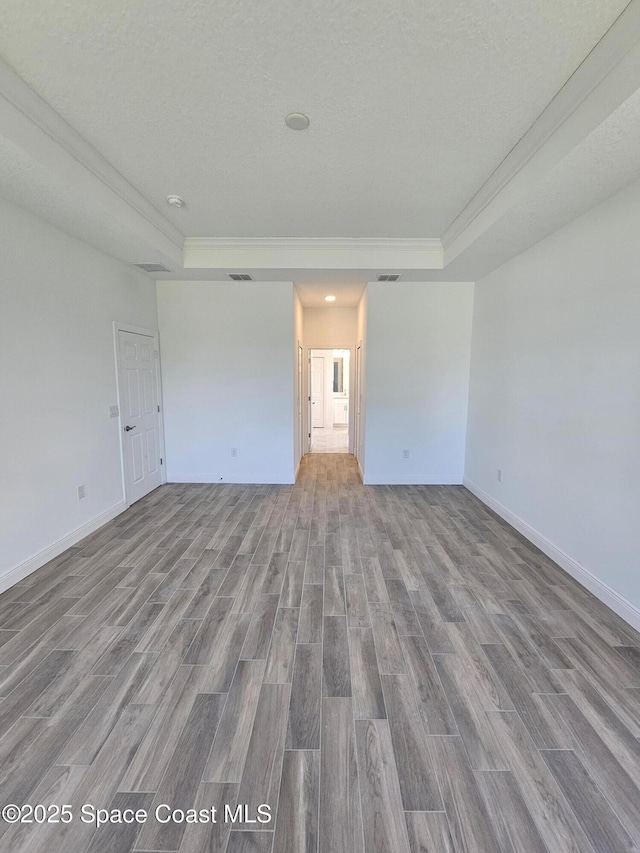 571 Fondulac St, Palm Bay, FL 32908 - unfurnished bedroom with a raised ceiling, wood finished floors, and crown molding