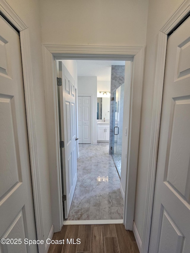 571 Fondulac St, Palm Bay, FL 32908 - corridor featuring wood finished floors and baseboards