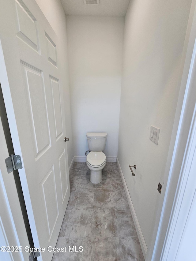 571 Fondulac St, Palm Bay, FL 32908 - bathroom featuring toilet and baseboards