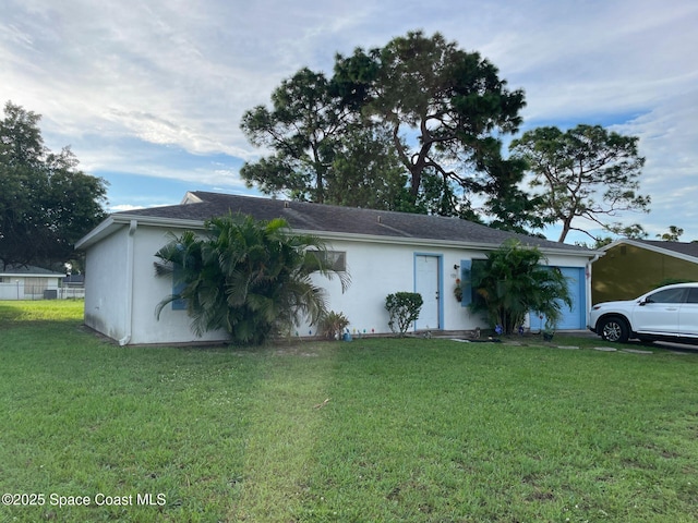 933 Gueld Ave NE, Palm Bay, FL 32905 - ranch-style home featuring a garage, a front yard, and stucco siding