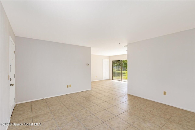 933 Gueld Ave NE, Palm Bay, FL 32905 - unfurnished room with light tile patterned flooring and baseboards