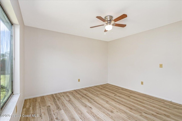933 Gueld Ave NE, Palm Bay, FL 32905 - unfurnished room featuring light wood-style flooring, plenty of natural light, and ceiling fan