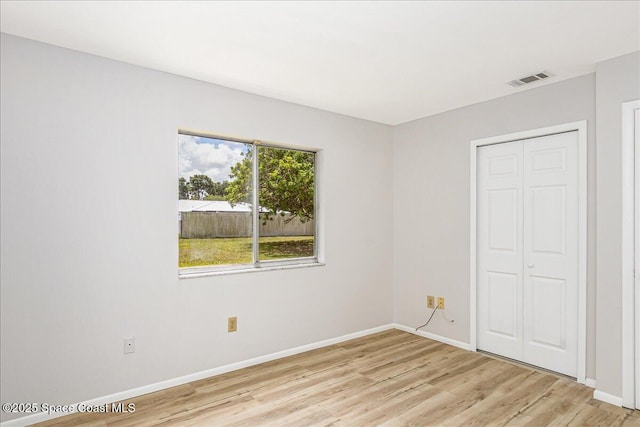 933 Gueld Ave NE, Palm Bay, FL 32905 - unfurnished bedroom with light wood-style flooring and a closet