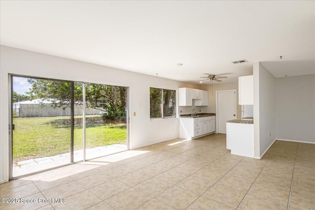 933 Gueld Ave NE, Palm Bay, FL 32905 - unfurnished living room with plenty of natural light, light tile patterned floors, and ceiling fan