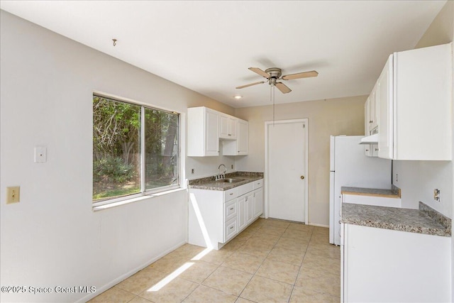 933 Gueld Ave NE, Palm Bay, FL 32905 - kitchen featuring ceiling fan, white cabinets, under cabinet range hood, and light tile patterned floors